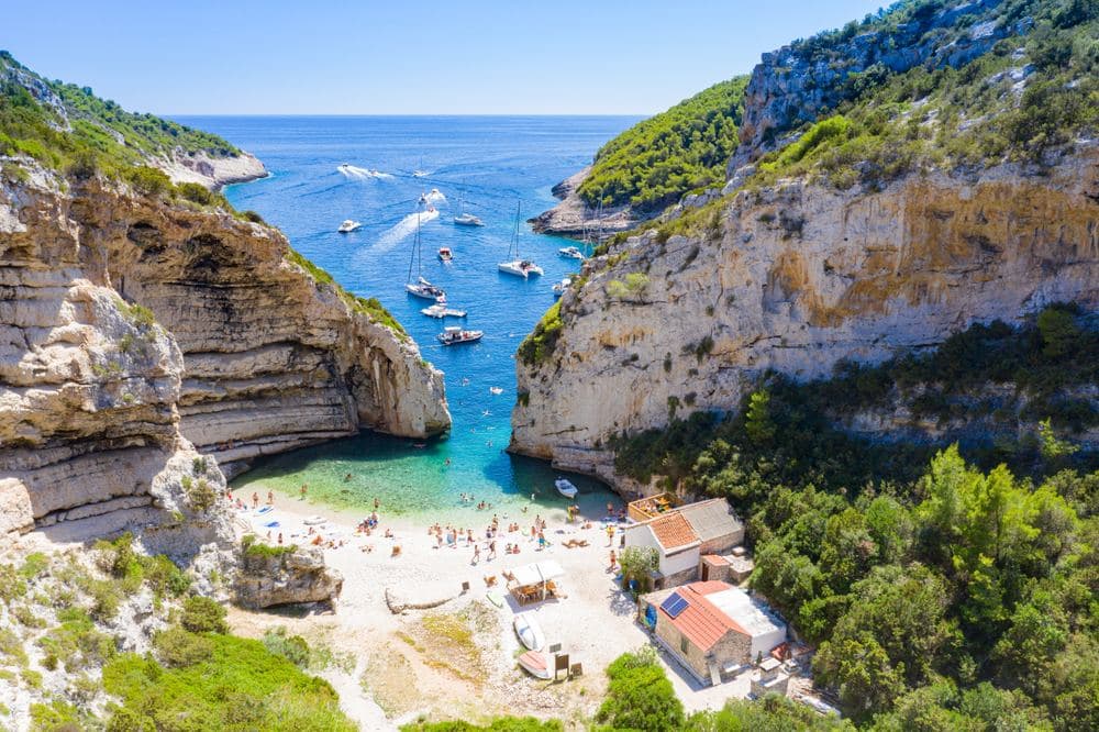 Stiniva on Vis, the cove between two cliffs that a path and a taxi boat reach