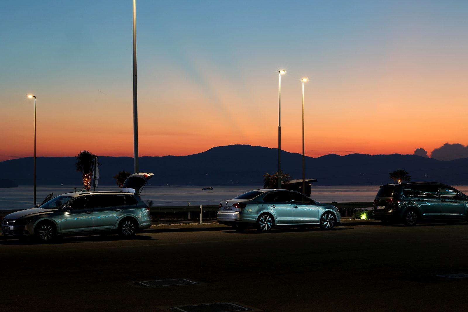 Cars on the forecourt of Adria Petrol with the sunset over the Kvarner Bay