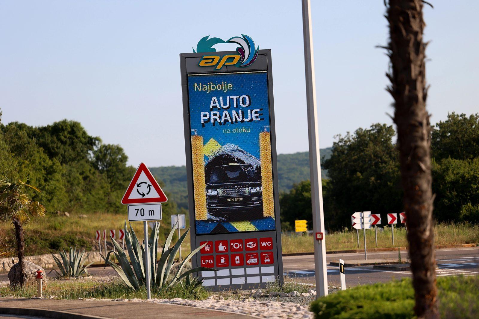 The roadside totem of Adria Petrol on the D102 advertising the car wash